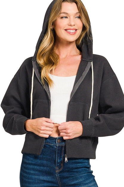 Woman wearing a black hoodie with a white background