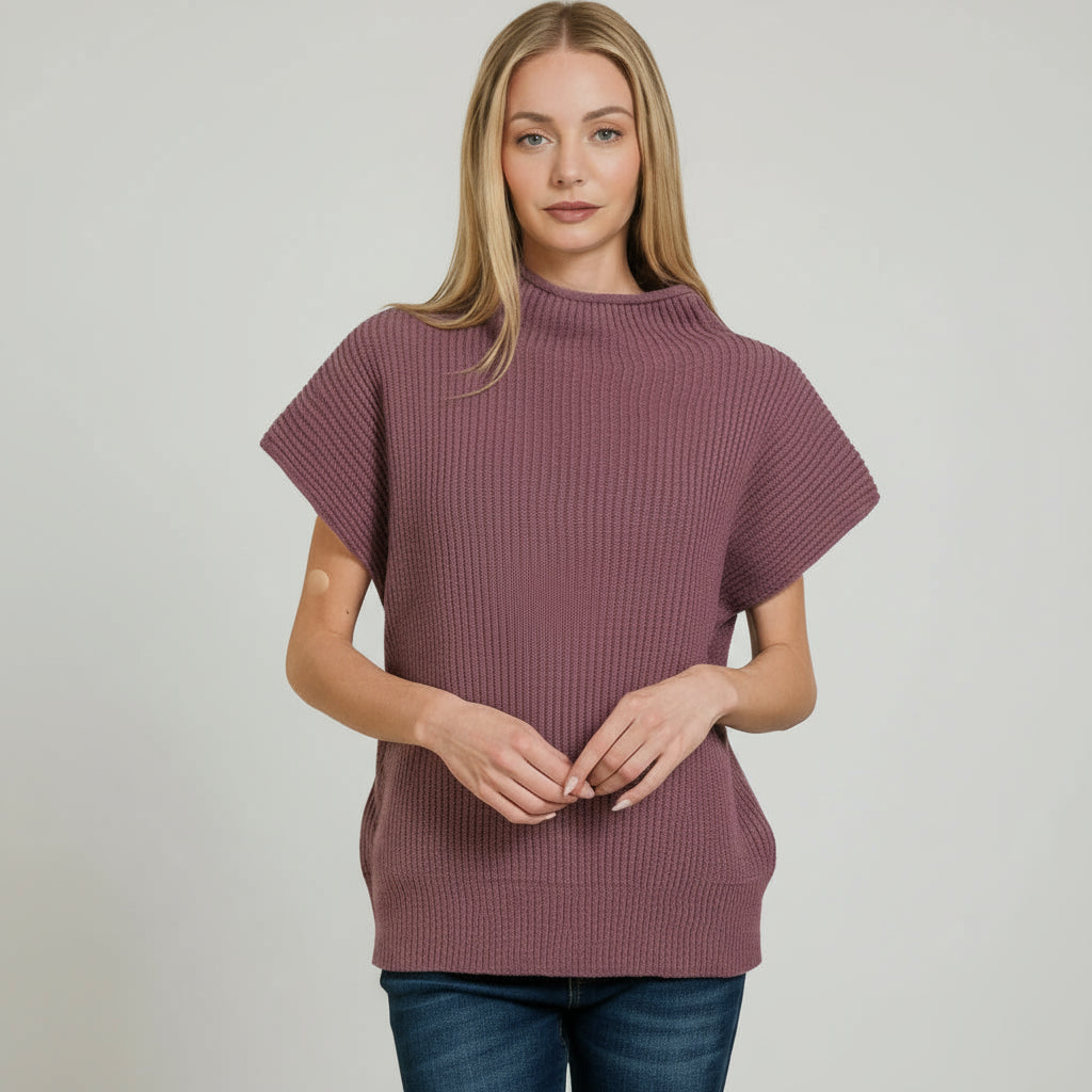 Woman wearing a purple ribbed sweater on a white background