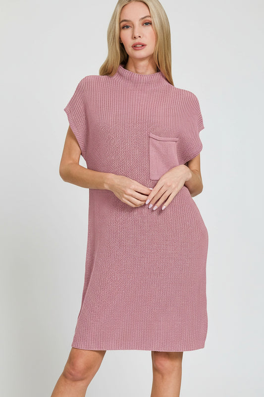 Woman wearing a light rose textured dress on a white background